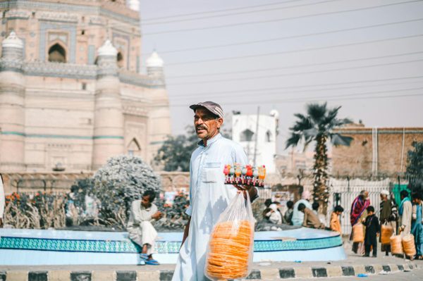 A street vendor selling drinks and snacks near a historic site in Multan, Pakistan.