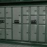 Secure metal lockers with electronic payment system at a station.