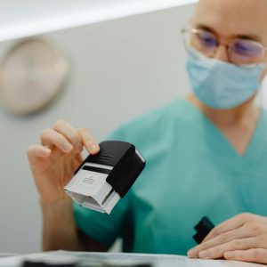 Healthcare worker stamping documents in a clinic setting, ensuring efficient workflow.