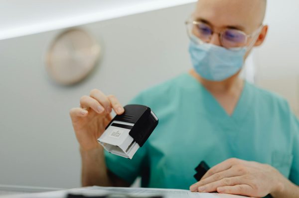 Healthcare worker stamping documents in a clinic setting, ensuring efficient workflow.
