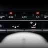 Close-up image of a car's climate control panel with digital temperature display.
