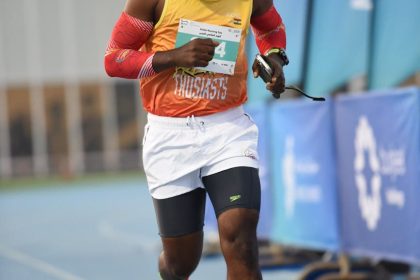 African male athlete participates in an Abu Dhabi marathon, showcasing determination and fitness outdoors.
