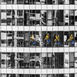 High-rise window cleaners in Dubai cleaning a skyscraper, showcasing urban architecture.