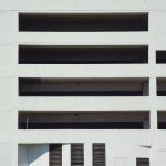 Close-up of a modern concrete building facade with architectural patterns.