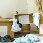 Cardboard boxes labeled keep, donate, and trash for effective home organization.