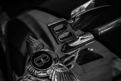 Stylish black and white close-up of Bentley car emblem, perfect for mobile wallpaper or luxury themes.