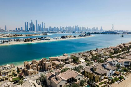 A breathtaking aerial view of Dubai's skyscrapers and luxury villas on a sunny day.