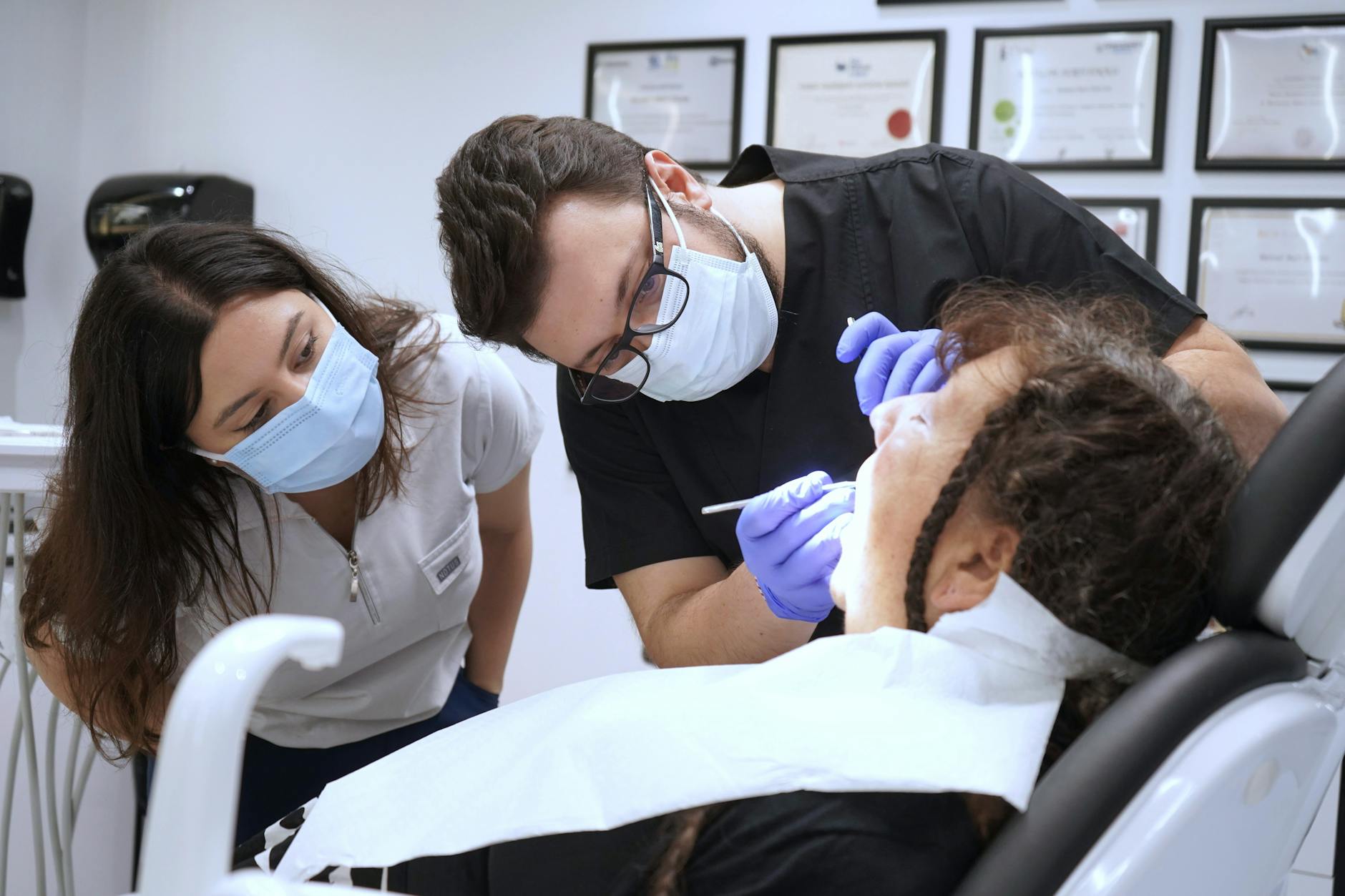 Dental professionals performing a procedure in a modern Istanbul clinic, showcasing teamwork and healthcare.
