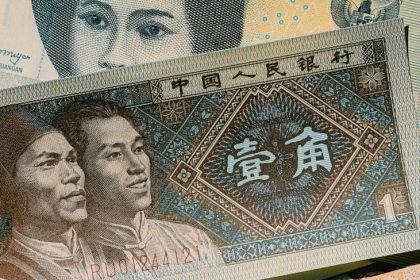 Vertical shot of various international banknotes displaying diverse currencies and designs.