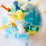 A vibrant globe with colorful pins marking destinations, symbolizing travel plans.