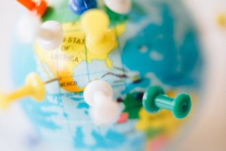 A vibrant globe with colorful pins marking destinations, symbolizing travel plans.