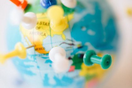 A vibrant globe with colorful pins marking destinations, symbolizing travel plans.